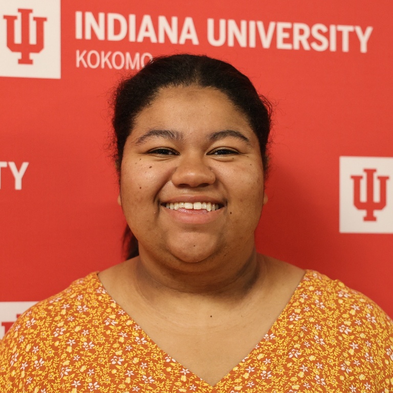 A portrait of a person smiling at the camera