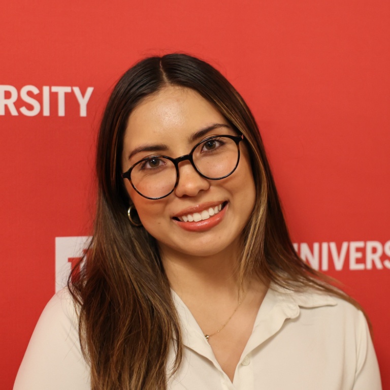 A portrait of a person smiling at the camera